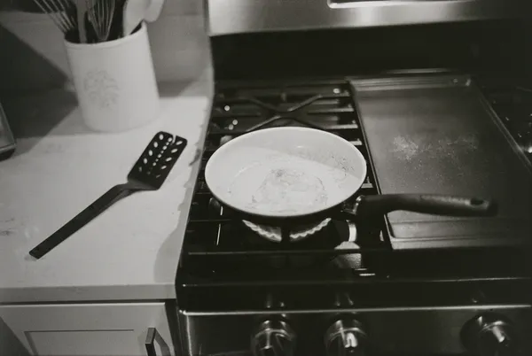 Black and white photo of pan on stove