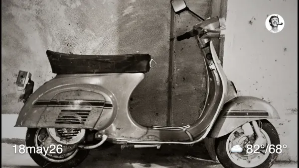Black and white film photo of a scooter