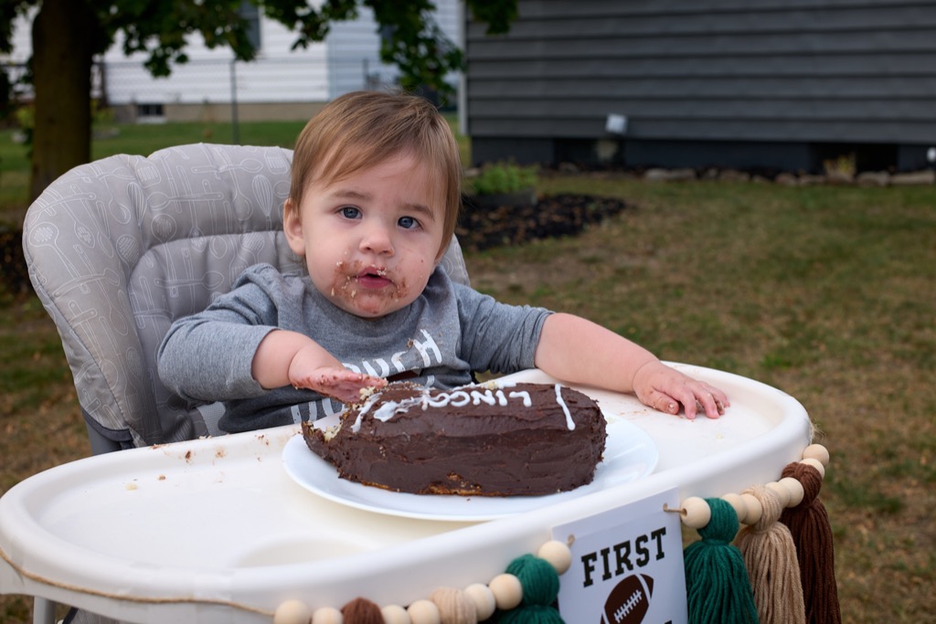 1-year old eating chocolate birthday cake