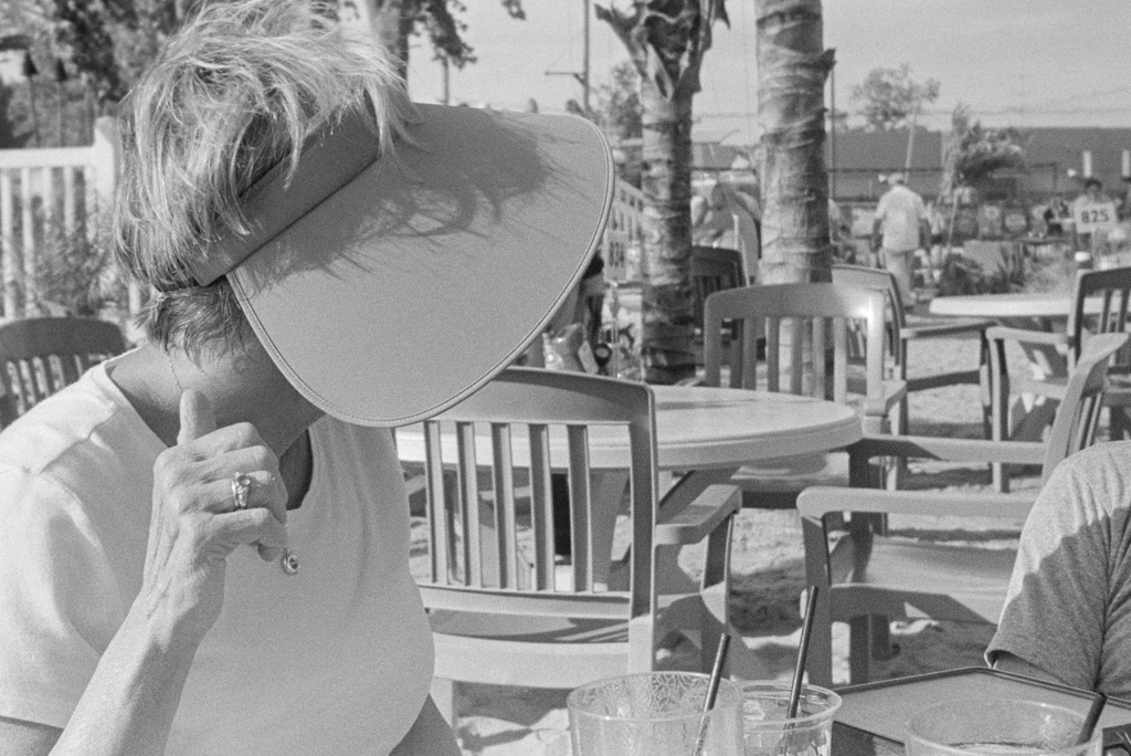 Black and white photo of woman in hat in profile