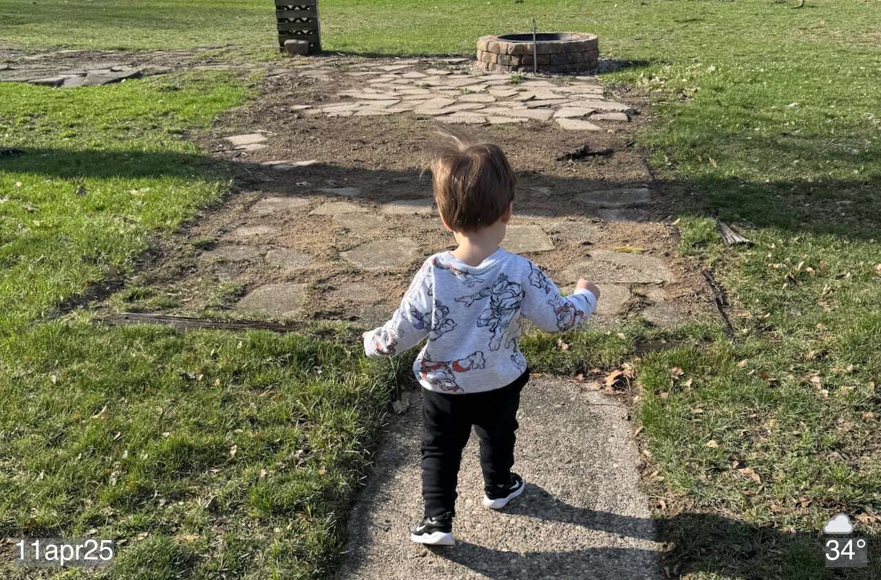 My grandson walking away from me in yard