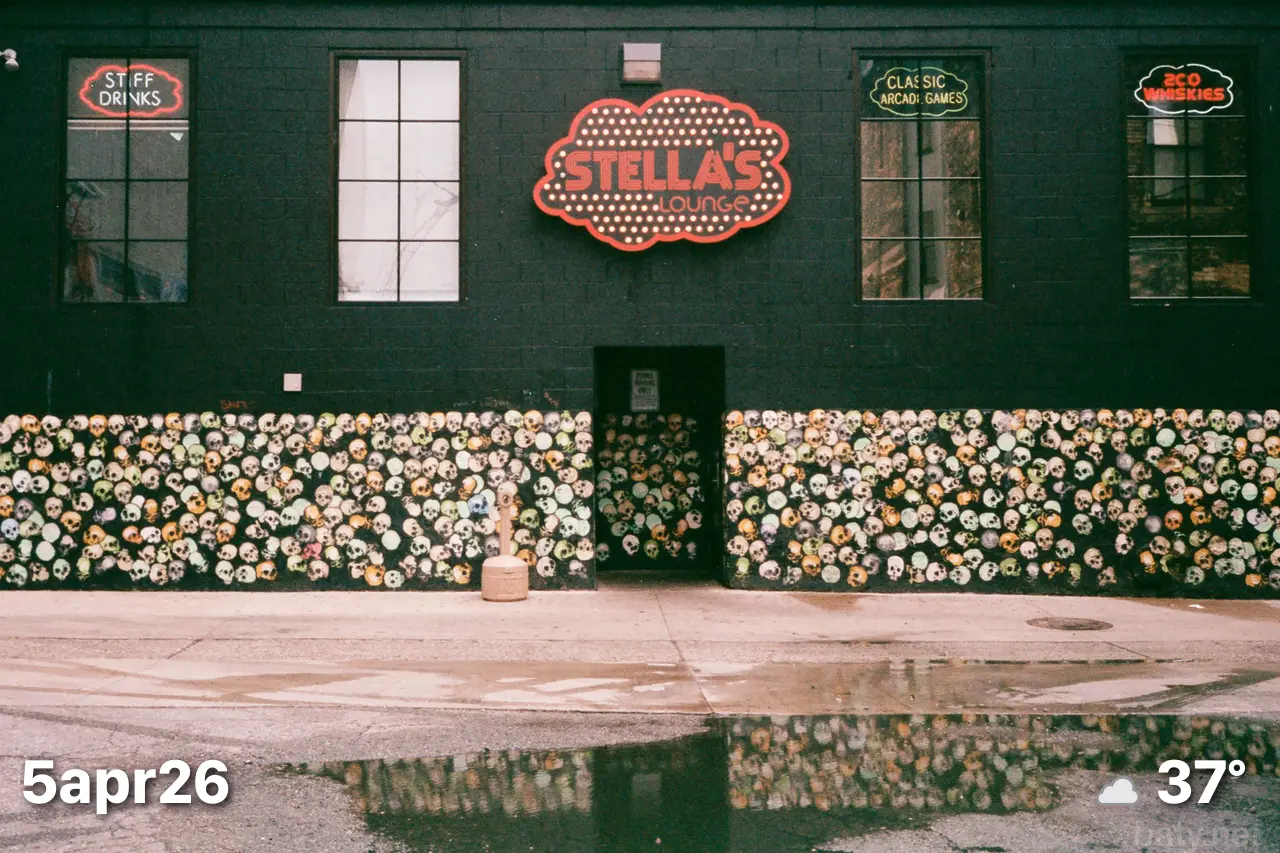Color film photo of the front of restaurant painted in a skull pattern