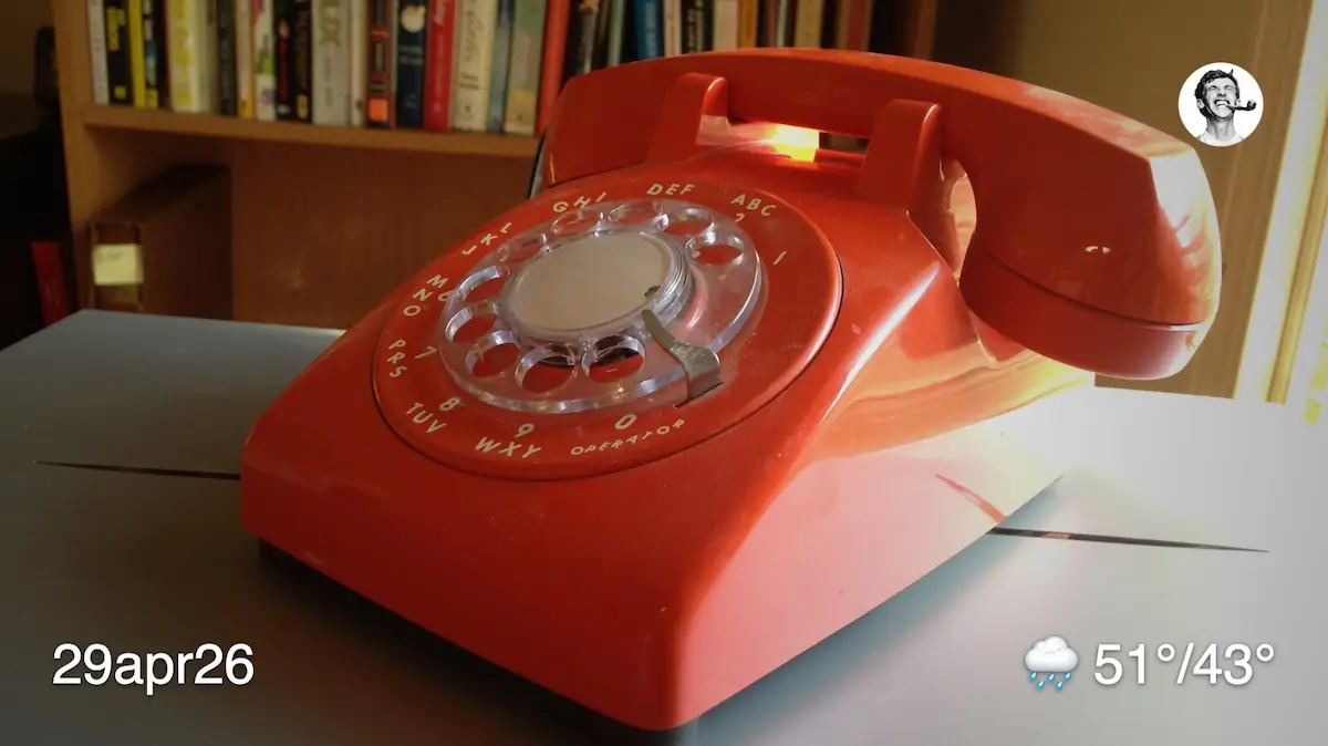 An orange rotary phone