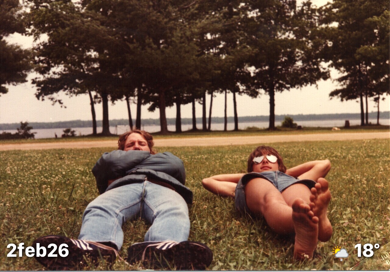 Two guys laying in the grass. Shot from ground-level.