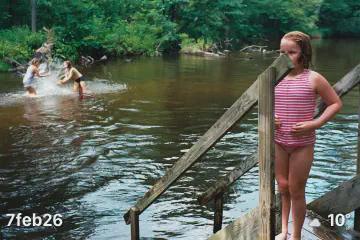 Kids in river and on small dock