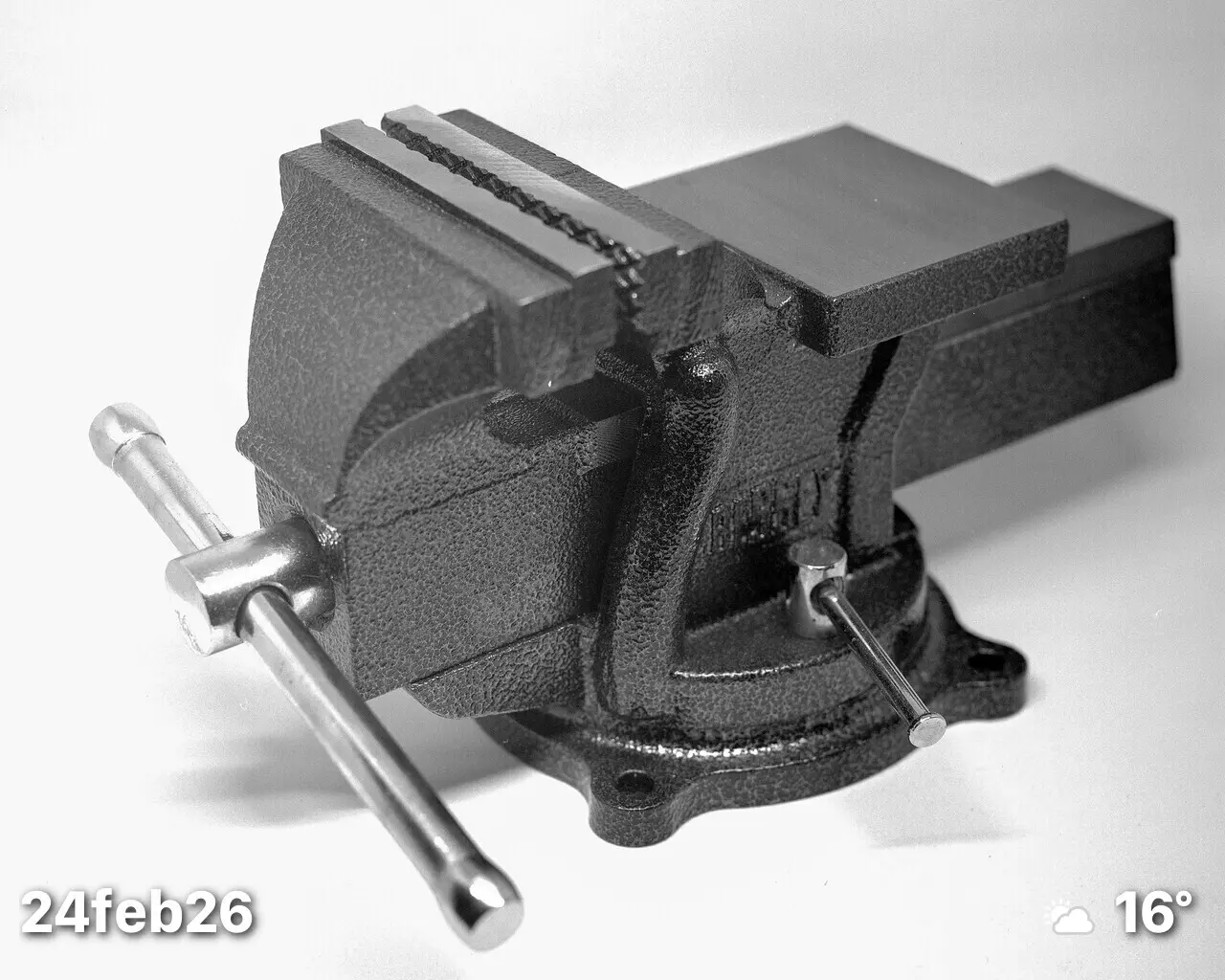 Large format black and white photo of a workbench vice