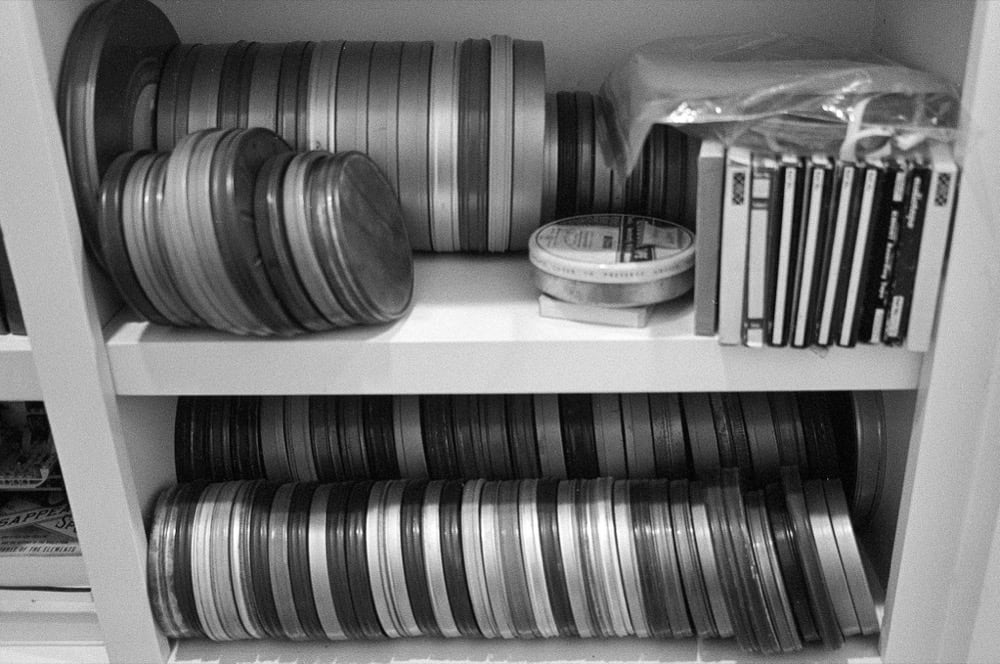 8mm movie film cannisters on shelves