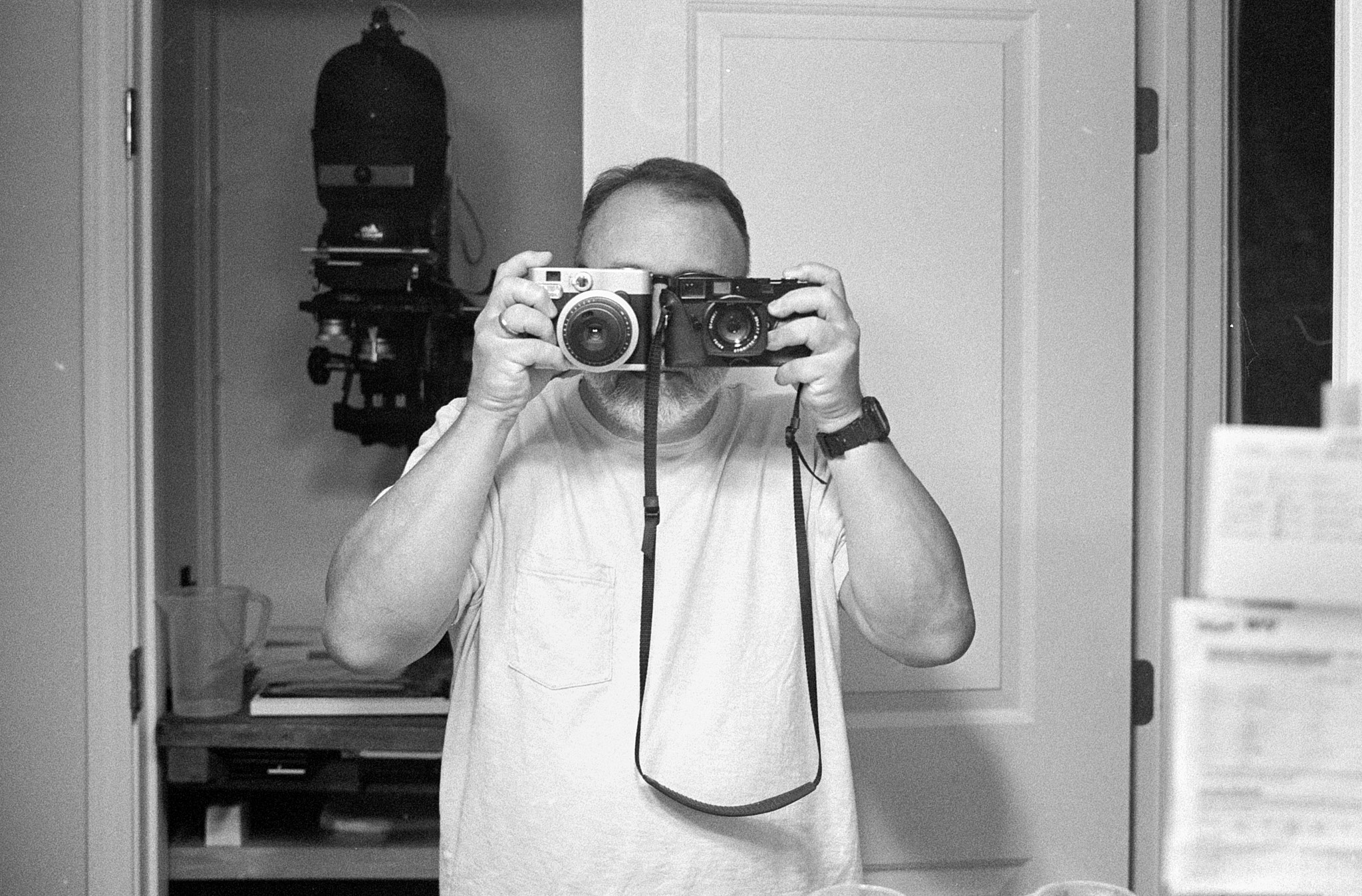 Self-portrait holding MP and Instax